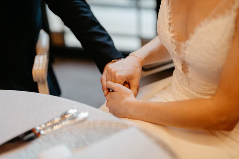 groom and bride listening to emotional speech at dinner reception