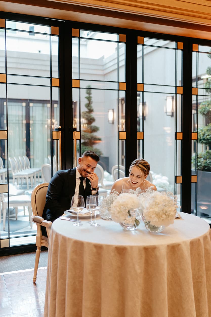 groom and bride listening to speech at dinner reception