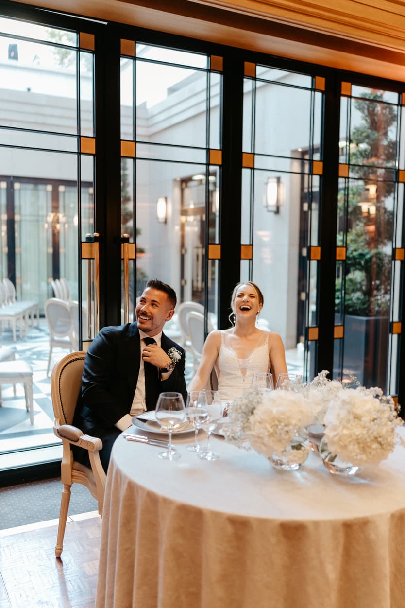 groom and bride listening to funny speech at dinner reception