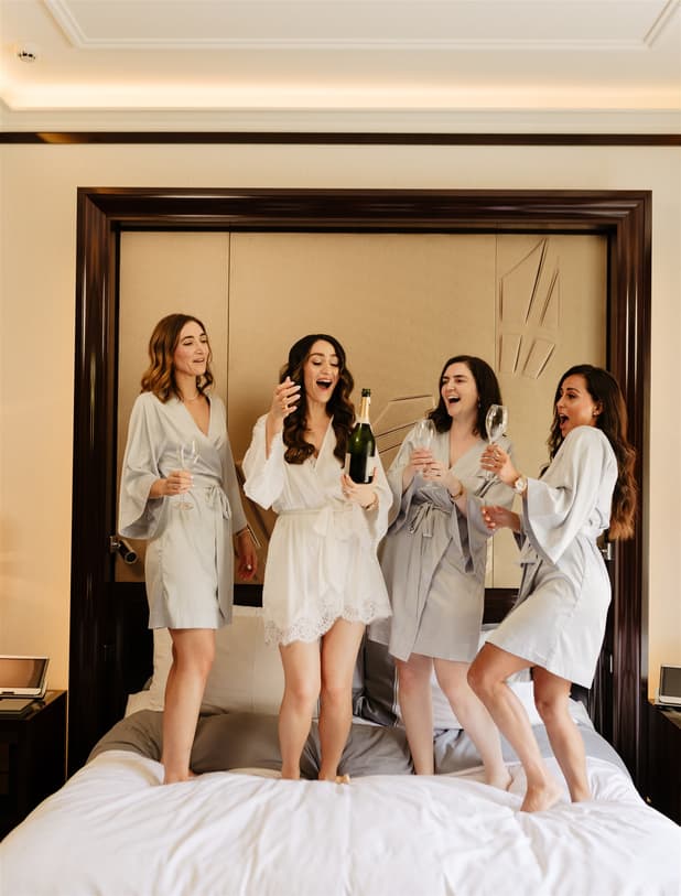 Bride team getting ready and celebrate with champgane in Peninsula paris wedding rooftop photographer