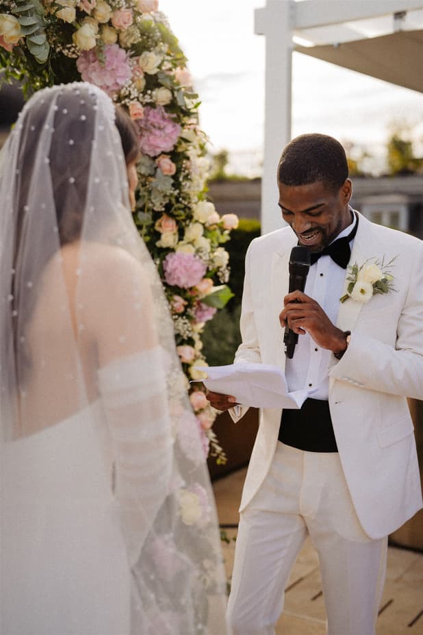 Emotional touching Groom exchanging vow at Paris Private Rooftop Wedding Ceremony at Peninsula Hotel with Eiffel Tower view