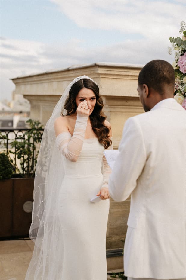 Emotional touching Bride exchanging vow at Paris Private Rooftop Wedding Ceremony at Peninsula Hotel with Eiffel Tower view