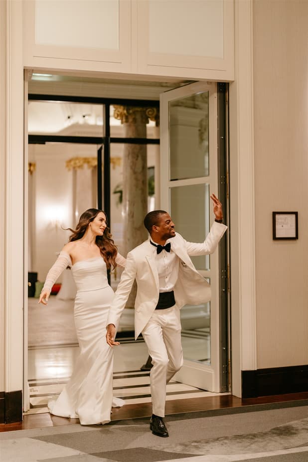 Black groom and white bride do iconic dancing entrances to dinner party 