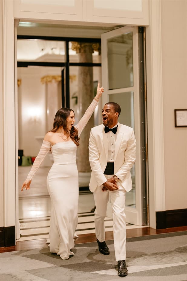 Black groom and white bride do iconic dancing entrances to dinner party