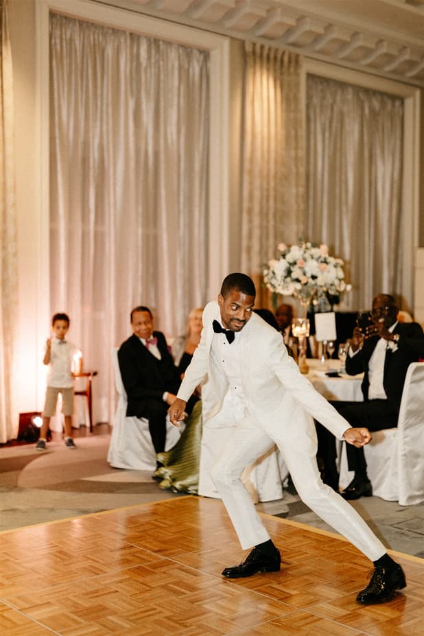 Black groom and white bride do iconic dancing entrances to dinner party