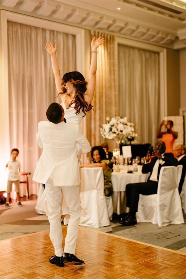 Black groom and white bride do iconic dancing entrances to dinner party