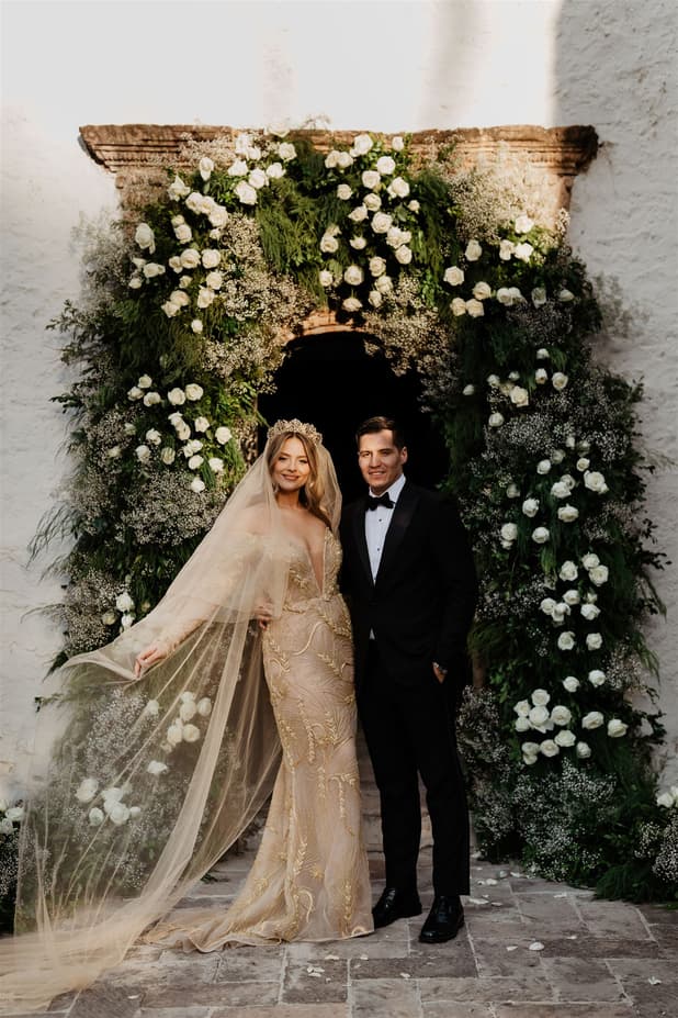 Groom andc Bride looks amazing with floral arch photographer