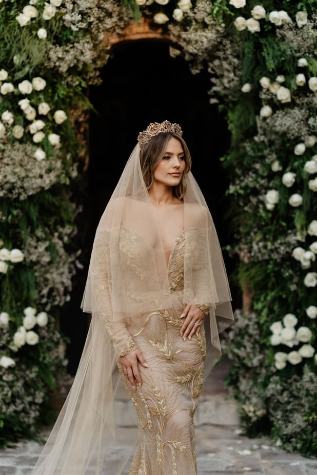 Bride looks fabulous with floral arch