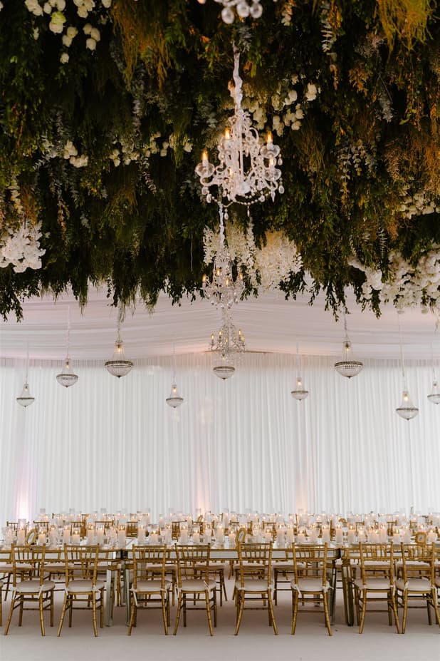 Wedding Reception Withe Golden Decoration with chandeliers, white flowers cascading from the ceiling and cancle lit in San Miguel de Allende Mexico / details photographer