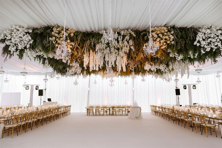 Wedding Reception Withe Golden Decoration with white flowers cascading from the ceiling and cancle lit in San Miguel de Allende Mexico