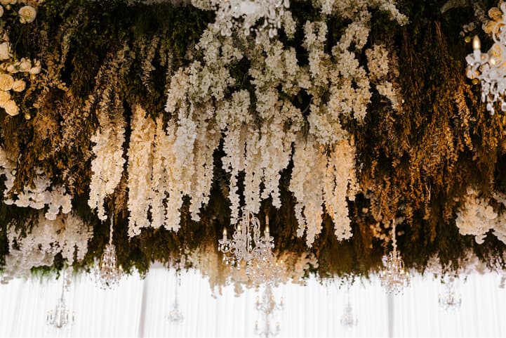 Wedding Reception Withe Golden Decoration with white flowers cascading from the ceiling and cancle lit in San Miguel de Allende Mexico / details photographer