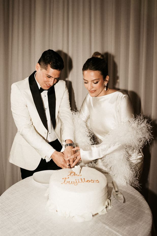 Groom and Bride cutting wedding cake