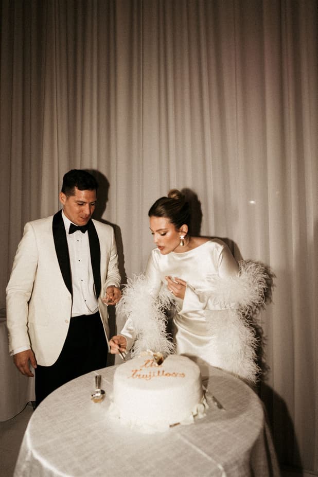 Groom and Bride cutting wedding cake