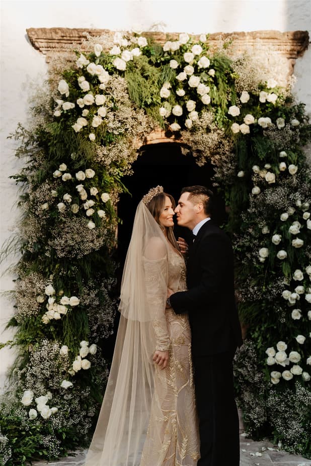 Groom andc Bride looks amazing with floral arch photographer