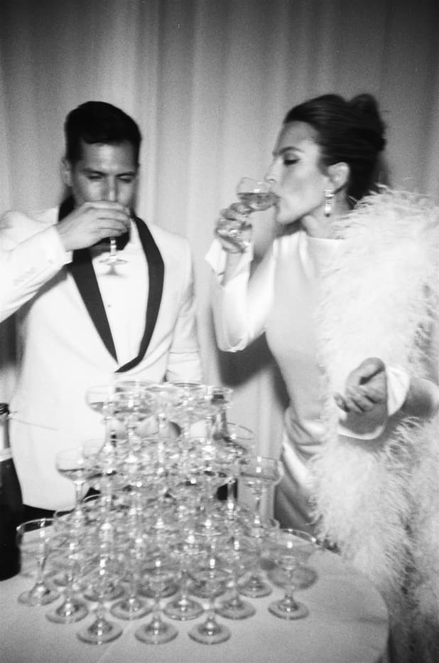 Groom and Bride celebrates with champagne tower and raise a toast/ cinematic B&W editorial wedding photographer
