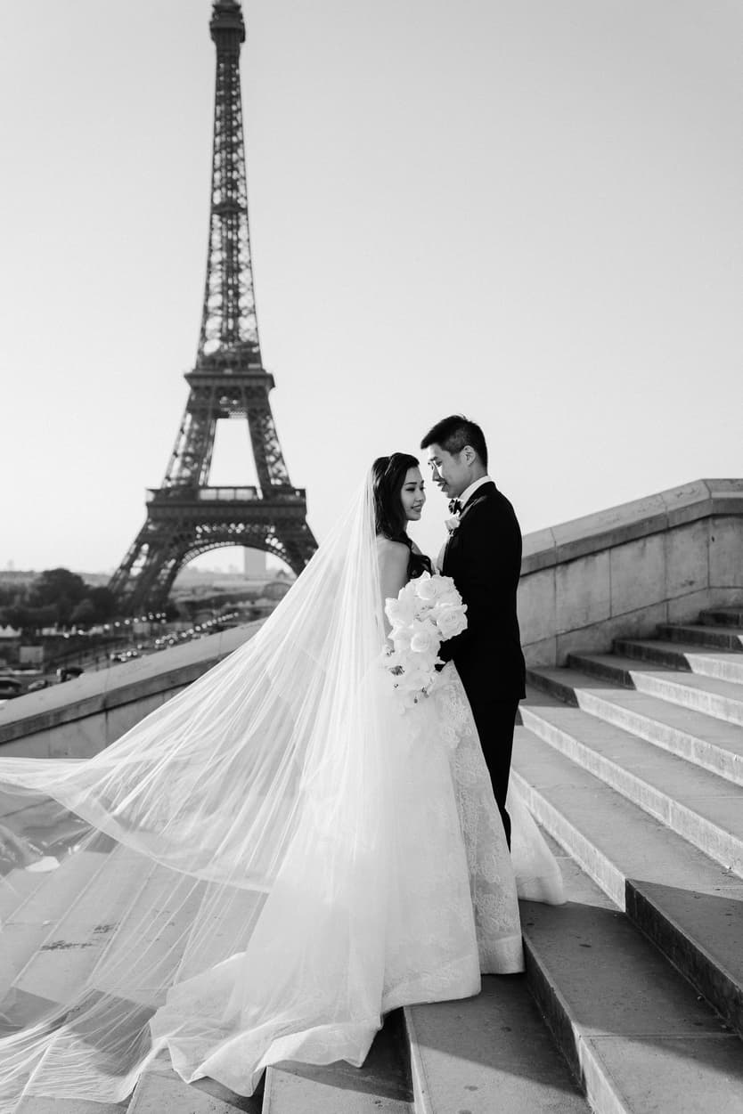 Orchid flower bouquet and Bride wearing Monique Lhuillier for her pre wedding in Paris at Place Trocadéro with Eiffel Tower view