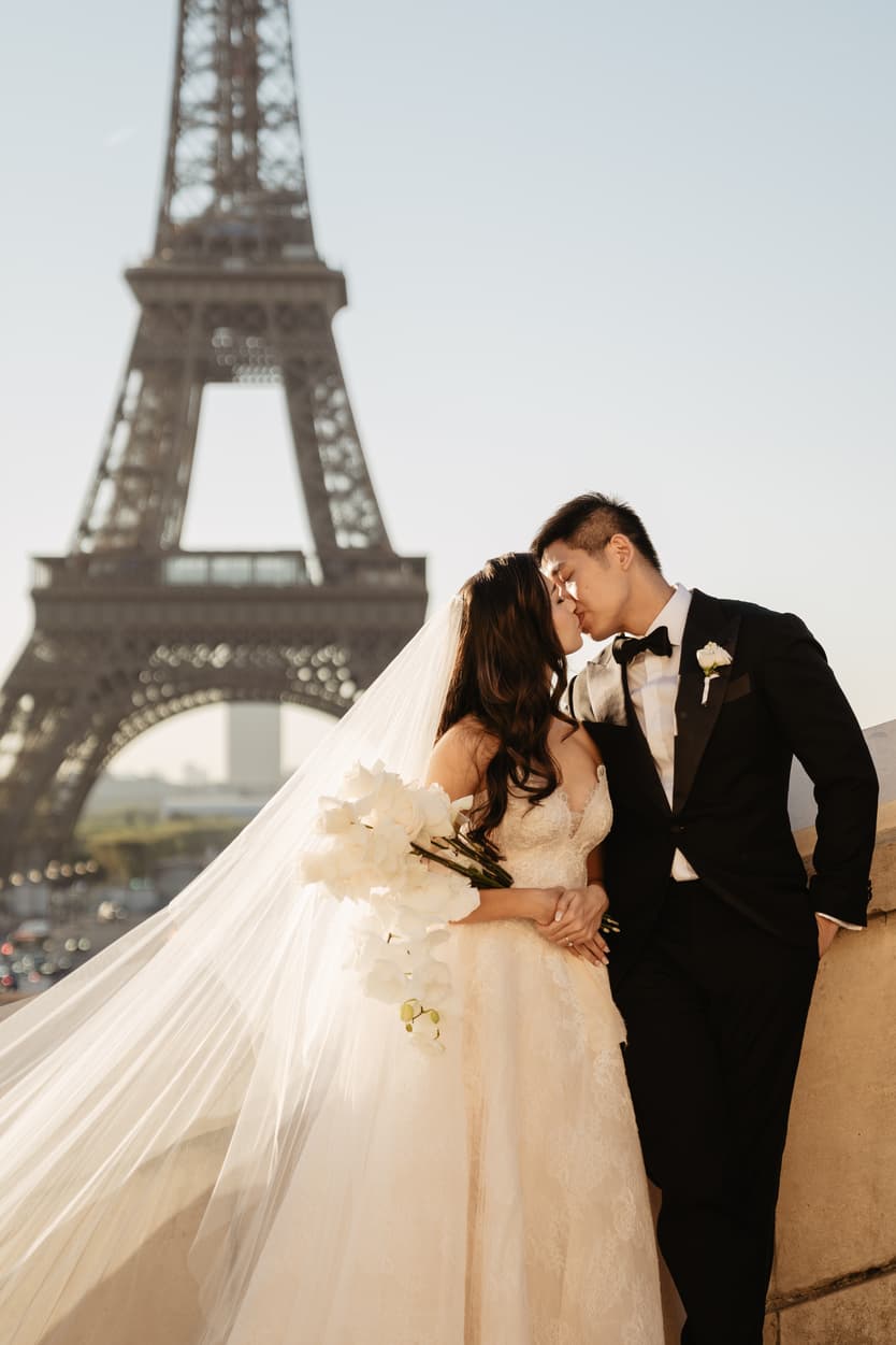 Orchid flower bouquet and Bride wearing Monique Lhuillier for her pre wedding in Paris at Place Trocadéro with Eiffel Tower view