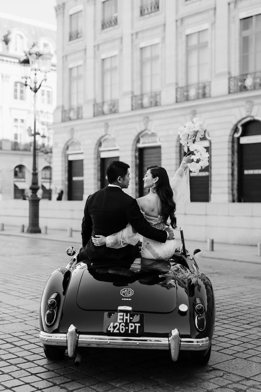 bride wearing Galia Lahav for her wedding in Paris at Place Vendome vintage car