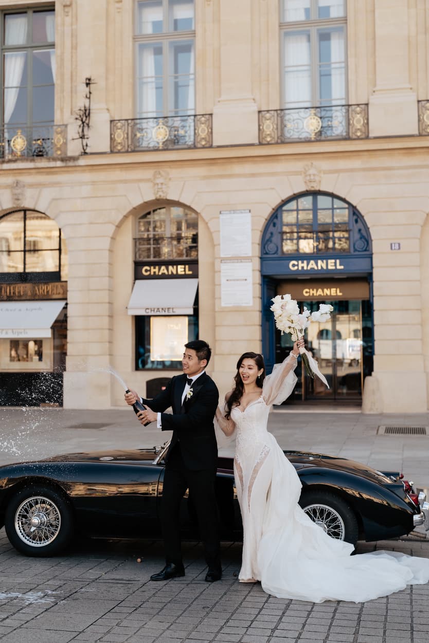 bride wearing Galia Lahav for her wedding in Paris at Place Vendome vintage car and champagne shower