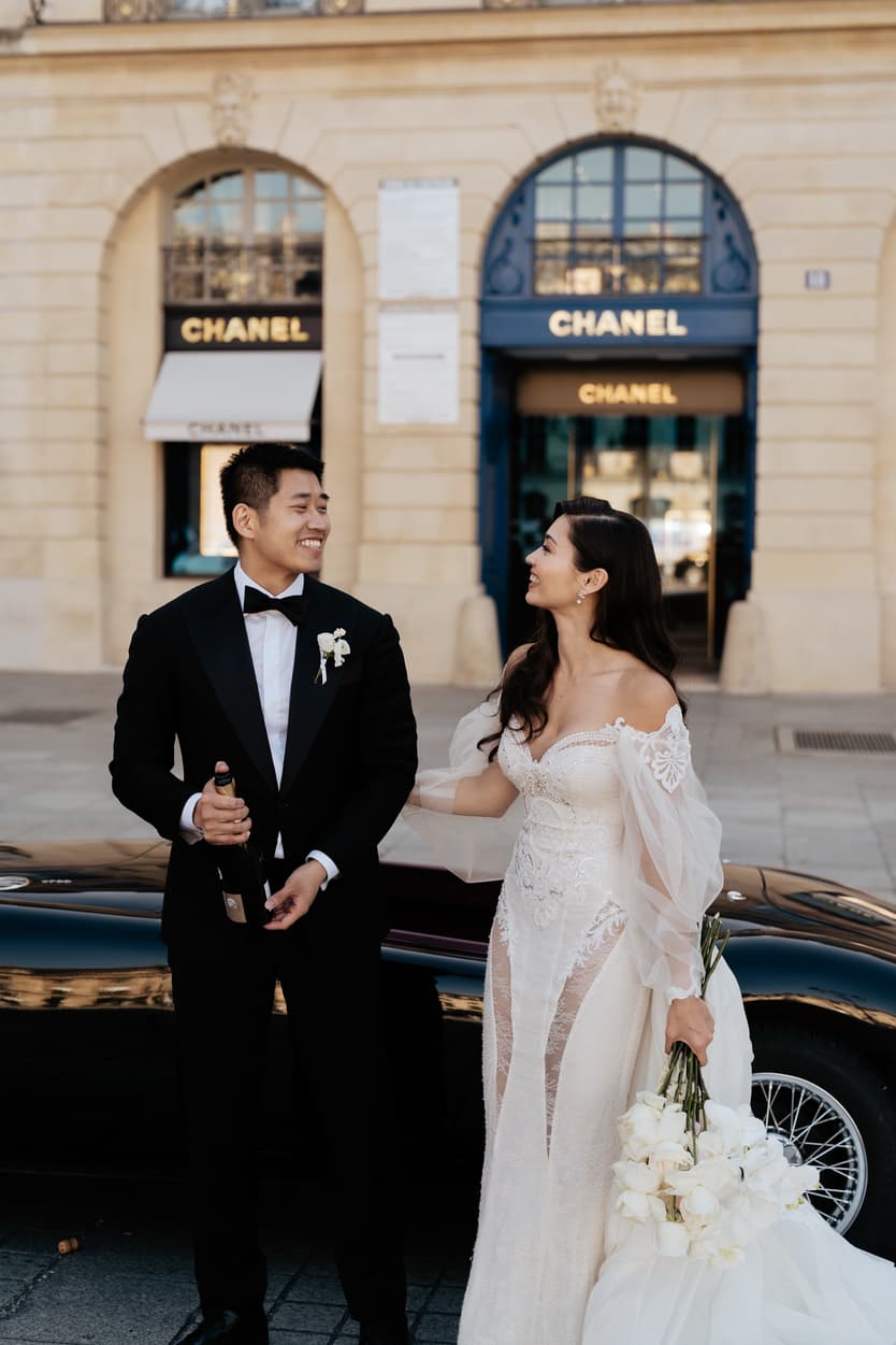 bride wearing Galia Lahav for her wedding in Paris at Place Vendome vintage car and champagne shower