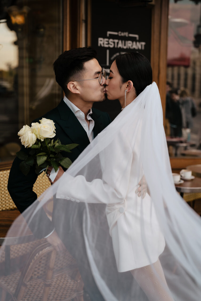 Romantic Paris Sunset Prewedding bride and groom kissing in a café