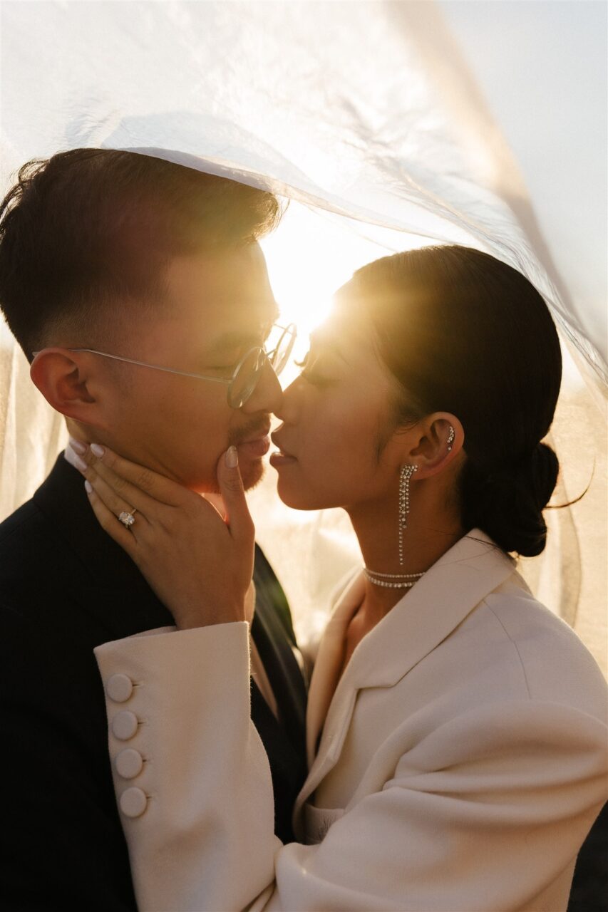 Close-up of a couple kissing sunset pre-wedding