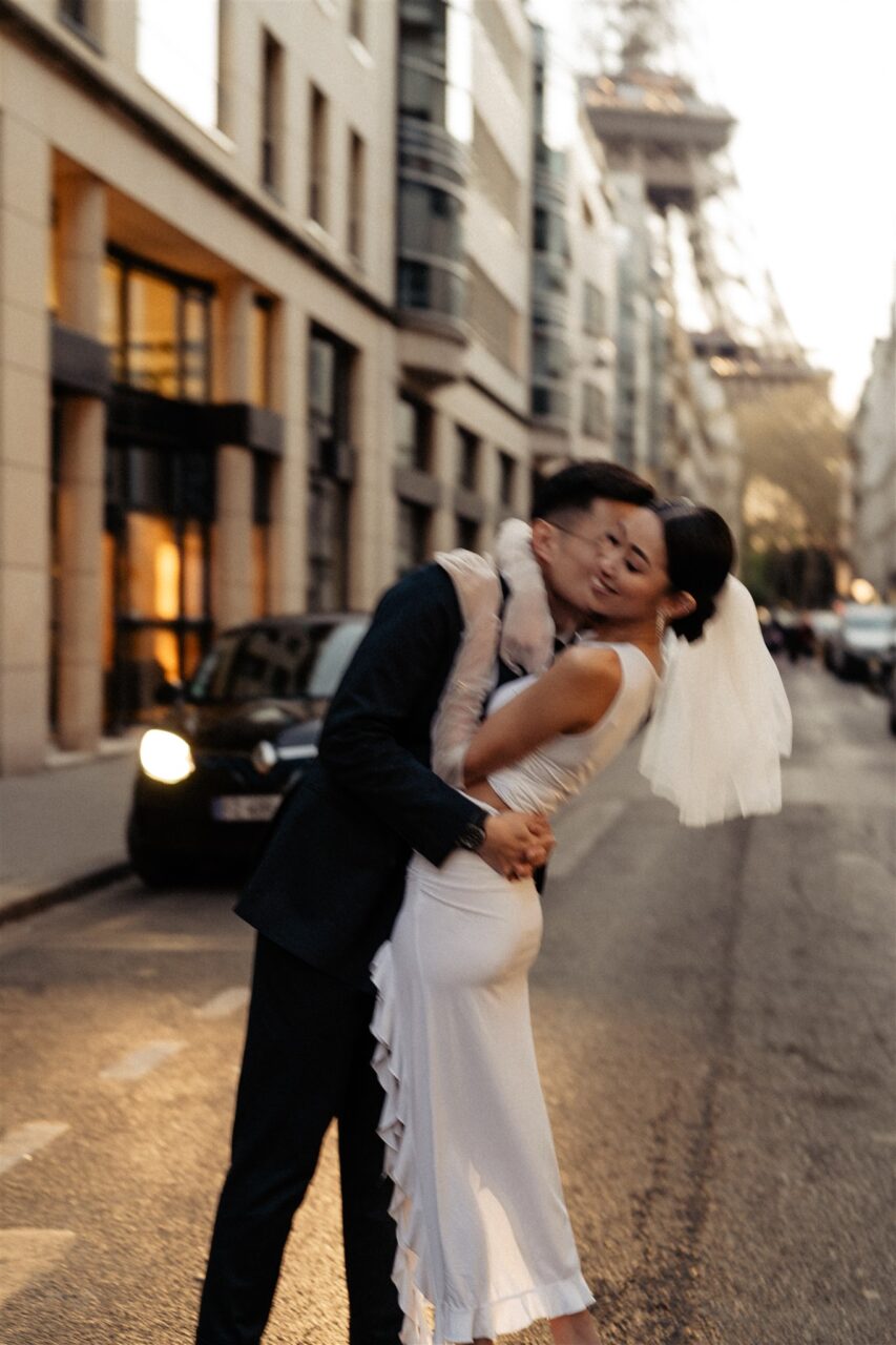 Romantic couple neck kissing with Eiffel tower view sunset pre-wedding
