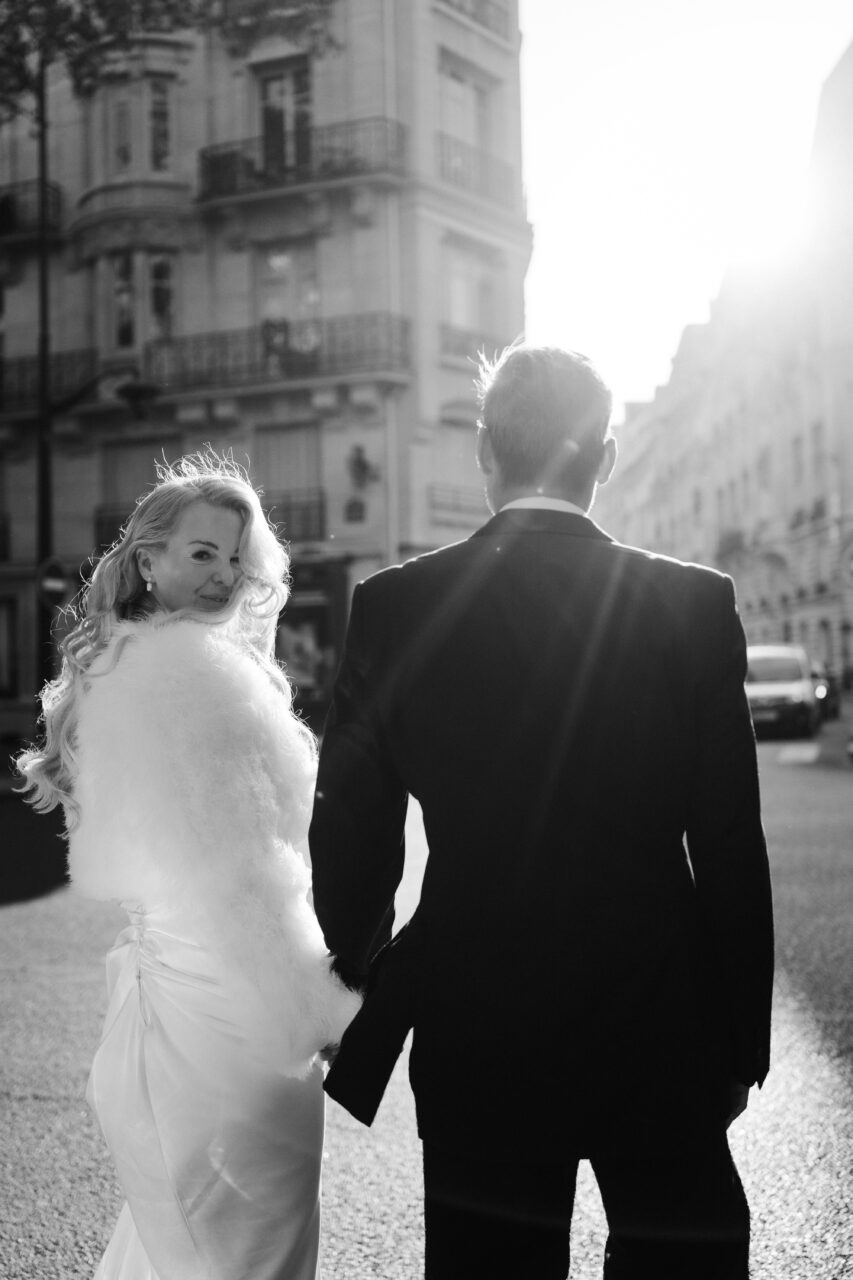 Bride and groom in Paris streets during their old hollywood elopement inpsired
