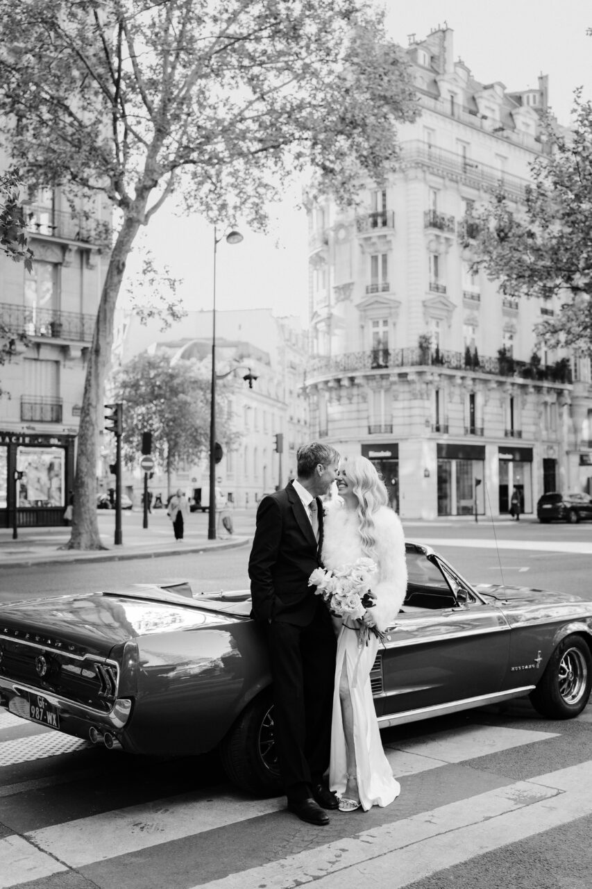 Parisian street view photoshoot during an old hollywood elopement in Paris with a vintage mustang car