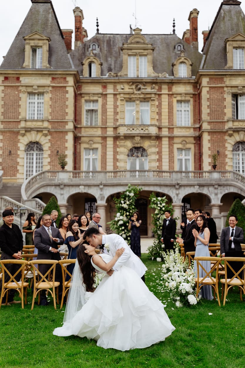 Bride and groom kissing at their wedding ceremony at Château Bouffémont