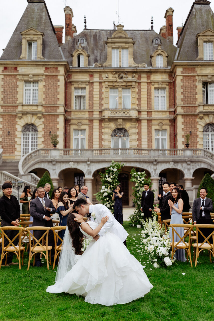 Bride and groom kissing at their wedding ceremony at Château Bouffémont