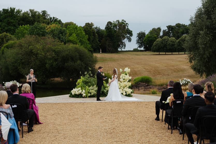 The wedding ceremony from the back of the aisle, the park of Château du Grand Lucé running away behind