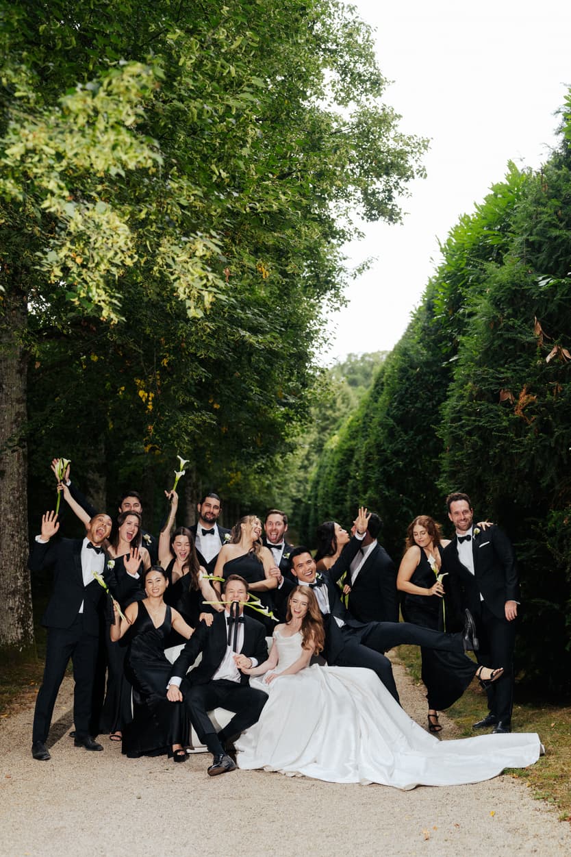 The bridal party in the green walk, bridesmaids in black silk with calla lilies and the bride in satin