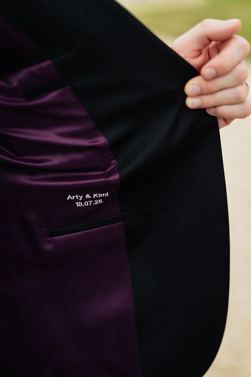 The wedding date embroidered inside the lining of the groom’s black tie jacket