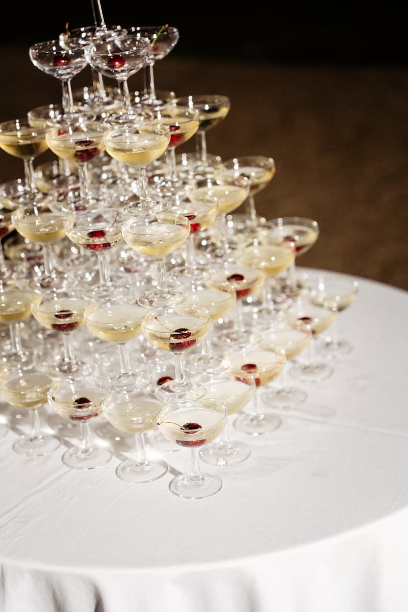 The champagne tower built on a table in the hall of Château du Grand Lucé, coupes stacked and full