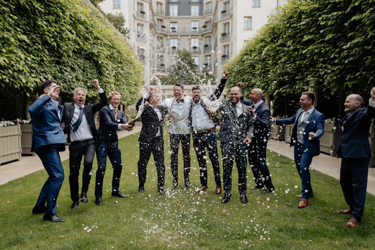 Groom and groomsmen champagne shower at the ritz summer wedding