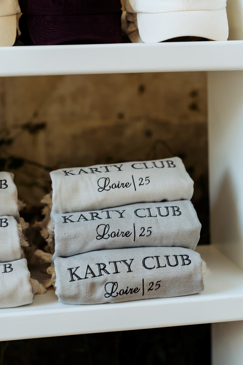 Towels embroidered Karty Club Loire 25 stacked on the cabana shelves at Château du Grand Lucé